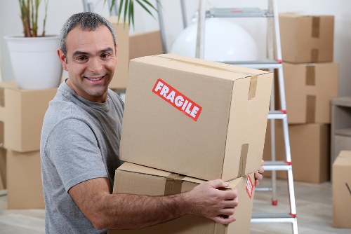 Man and van team loading furniture safely with protective care