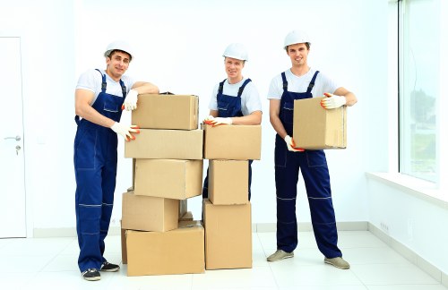 Professional furniture removals team handling a sofa in Millhill