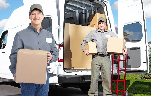 Professional movers handling equipment during commercial moves in Millhill